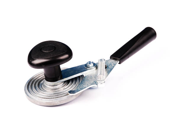 Machine for rolling metal caps on glass jar on white background.